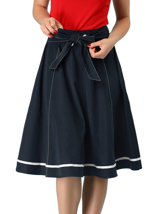 Falda elegante acampanada para mujer con lazo en la cintura y botones decorativos en contraste. Falda de corte A.